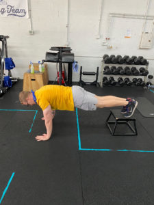 The top position of a feet elevated push up.