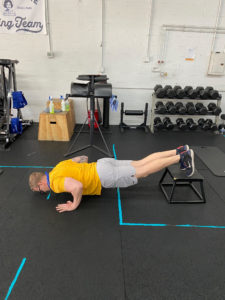 A progression that changes the angle of the body, shifting more weight into your hands to make push ups harder.