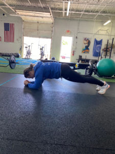 Plank - We want to engage our abs, quads and glutes as we actively push our elbows into the floor.