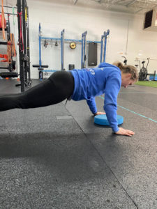 Notice the strong plank position. We place a pad underneath so we can make sure we hit a consistent range of motion on every rep.